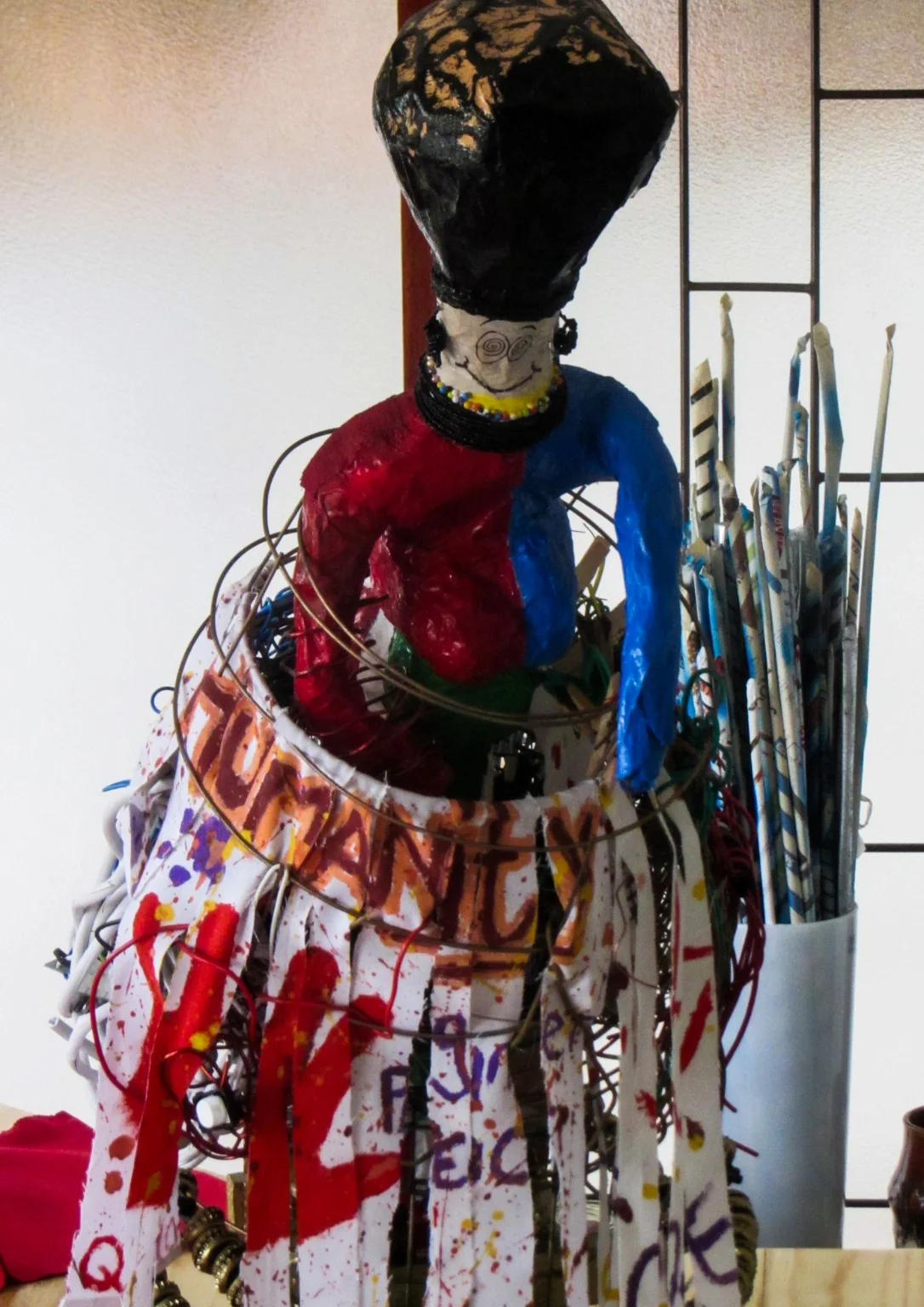 Neville Keith Matroos working on a mixed-media artwork in his studio